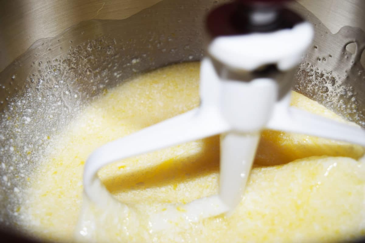 Red velvet cupcake wet ingredients in a mixer.