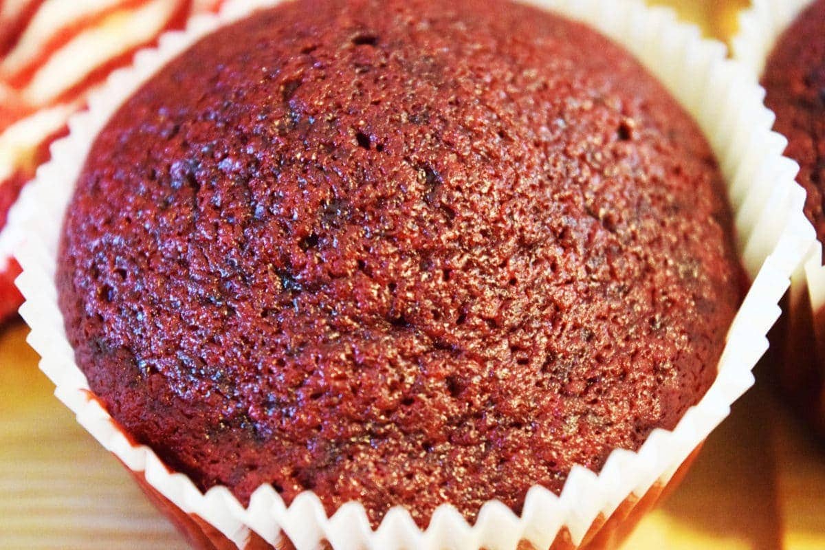 A red velvet cupcake unfrosted.