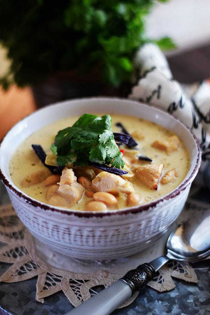a closeup of this stovetop white chicken chili recipe garnished with fresh parsley