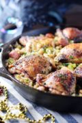 a closeup of this chicken and dirty rice skillet recipe in a black cast iron skillet
