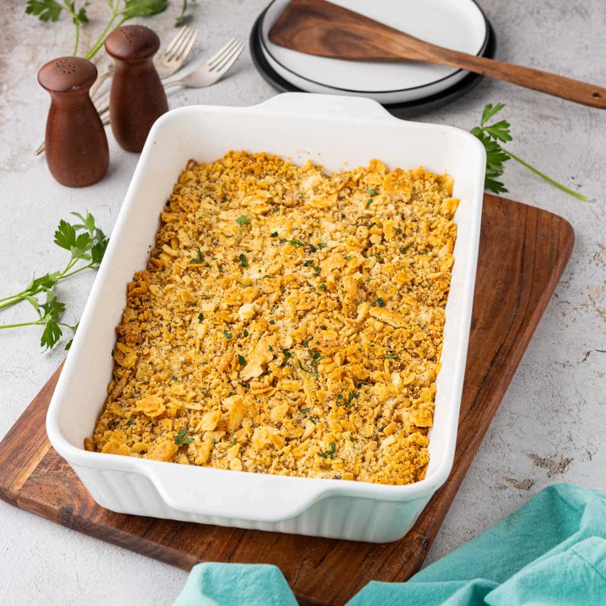 A baked poppy seed chicken casserole in a white casserole dish.
