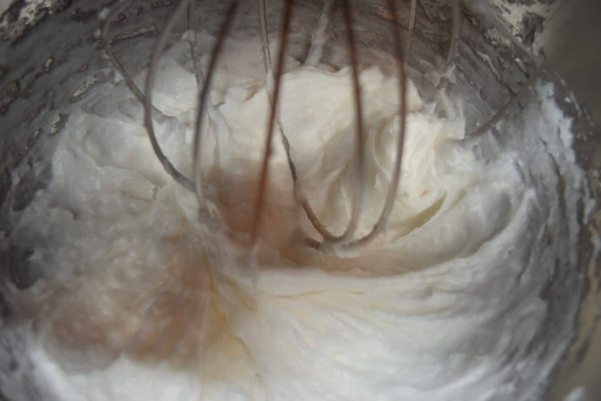 a closeup of whipped coconut oil inside of a stand mixer
