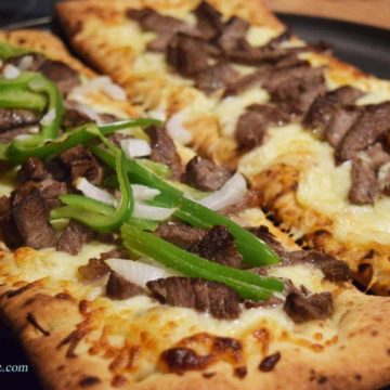 a closeup of this philly cheese steak pizza