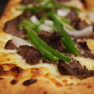 a closeup of this philly cheese steak pizza