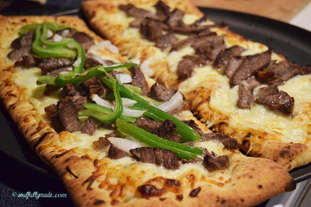 a closeup of this philly cheese steak pizza 