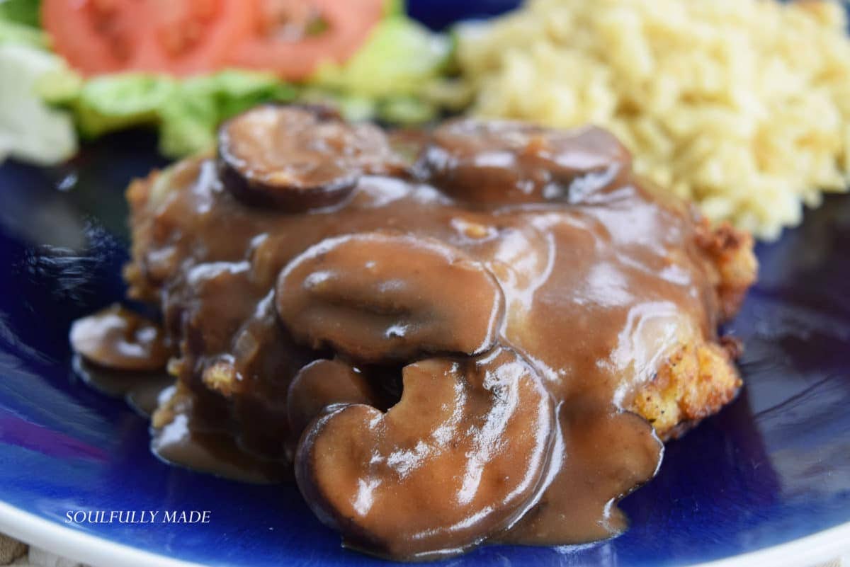 a closeup of a serving of this fontina pork chops with mushroom sauce recipe