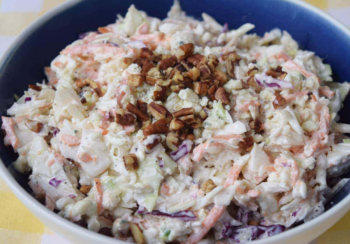 a large serving bowl filled with this homemade blue cheese coleslaw