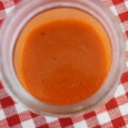 a glass bowl of homemade buffalo sauce