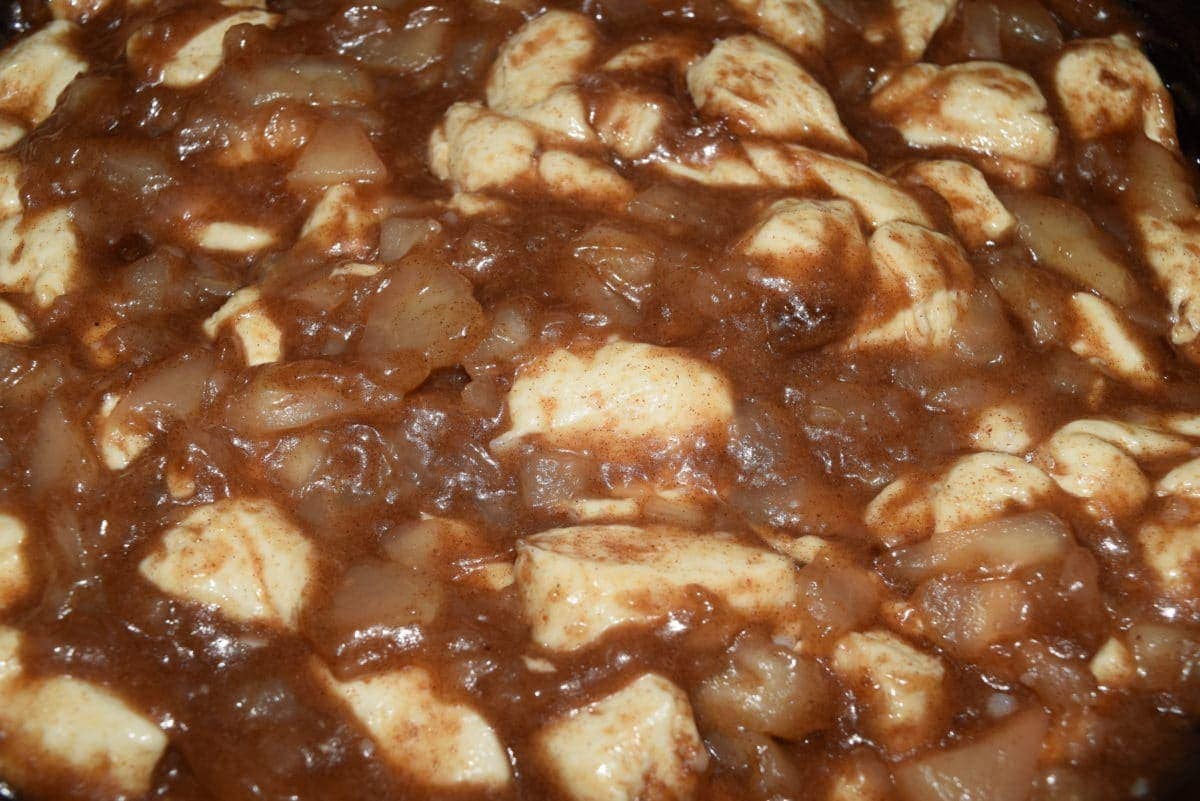 a closeup of the raw skillet apple pie biscuit bites in the skillet before baking