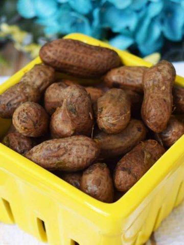 a yellow container filled with crock pot boiled peanuts