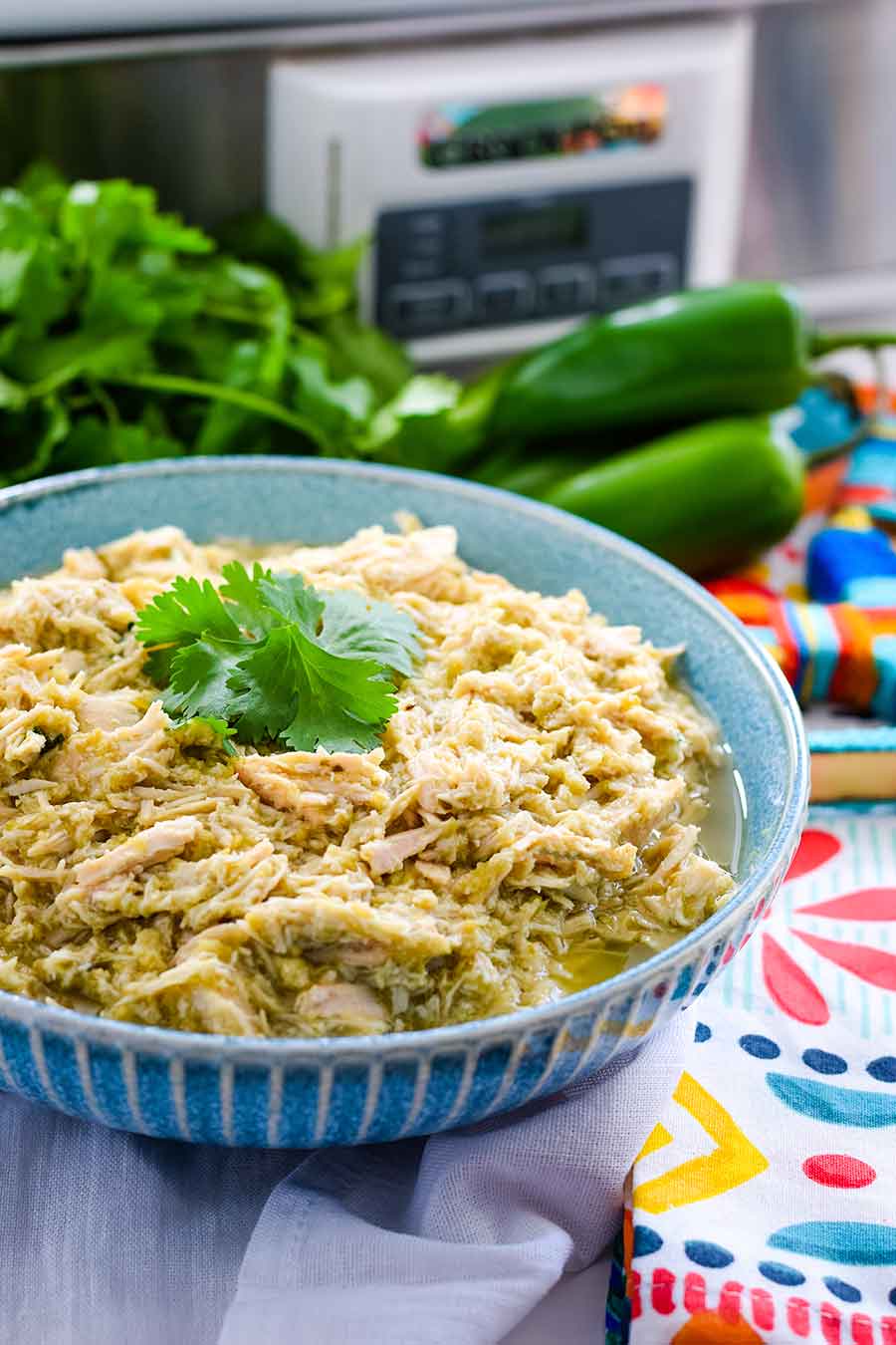 an overhead view of crock pot salsa verde chicken to be used in these salsa verde chicken street tacos 