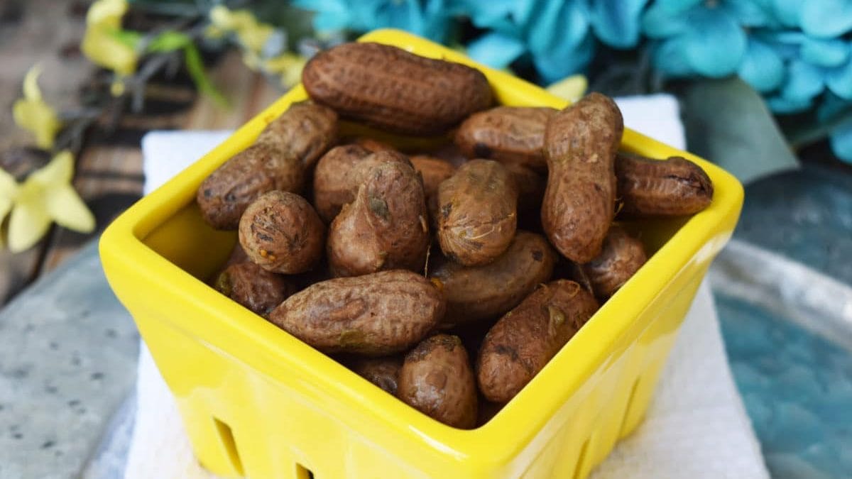 a small yellow produce basket filled with these crock pot boiled peanuts made in the slow cooker