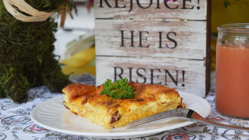 a slice of this overnight breakfast casserole served on a white plate for Easter breakfast or brunch 