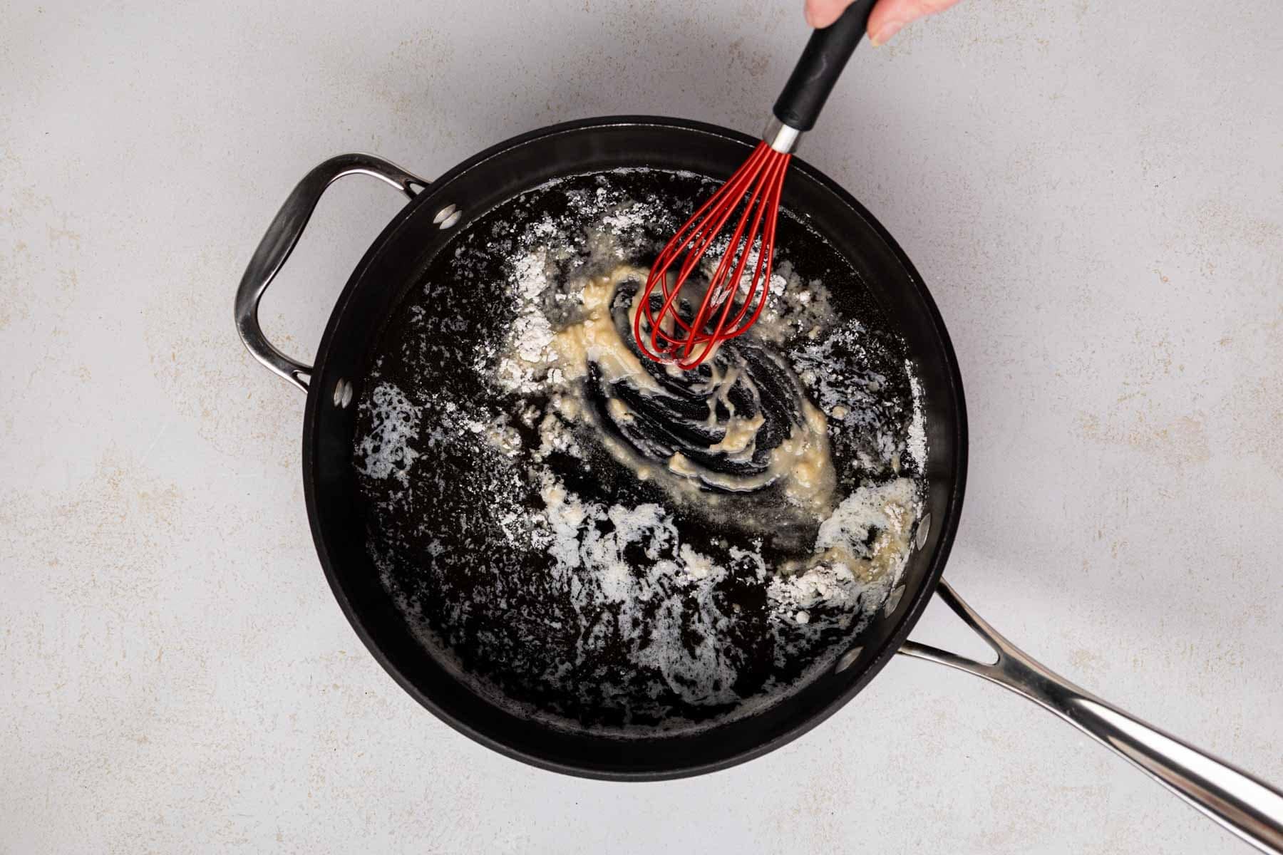 Flour added to melted butter in a skilled.