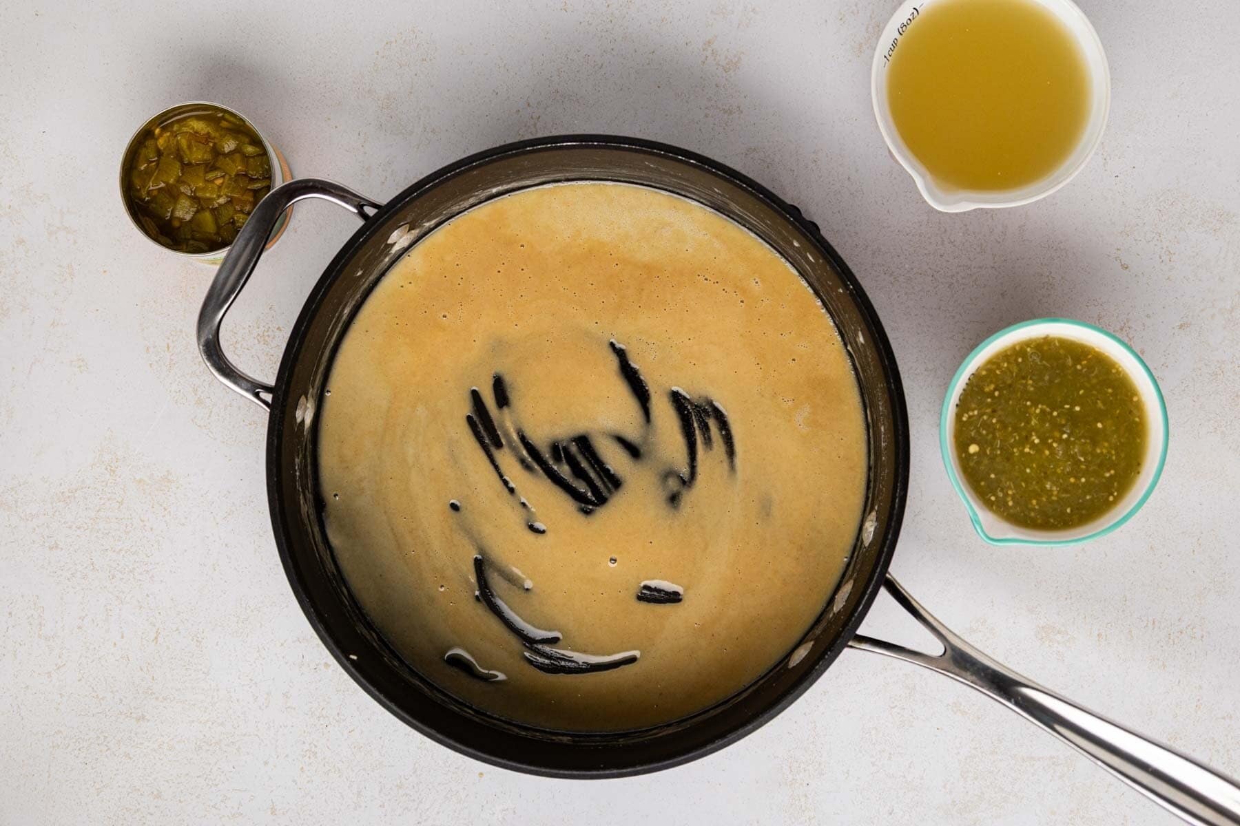 A flour roux after being whisked and cooked in a skillet.