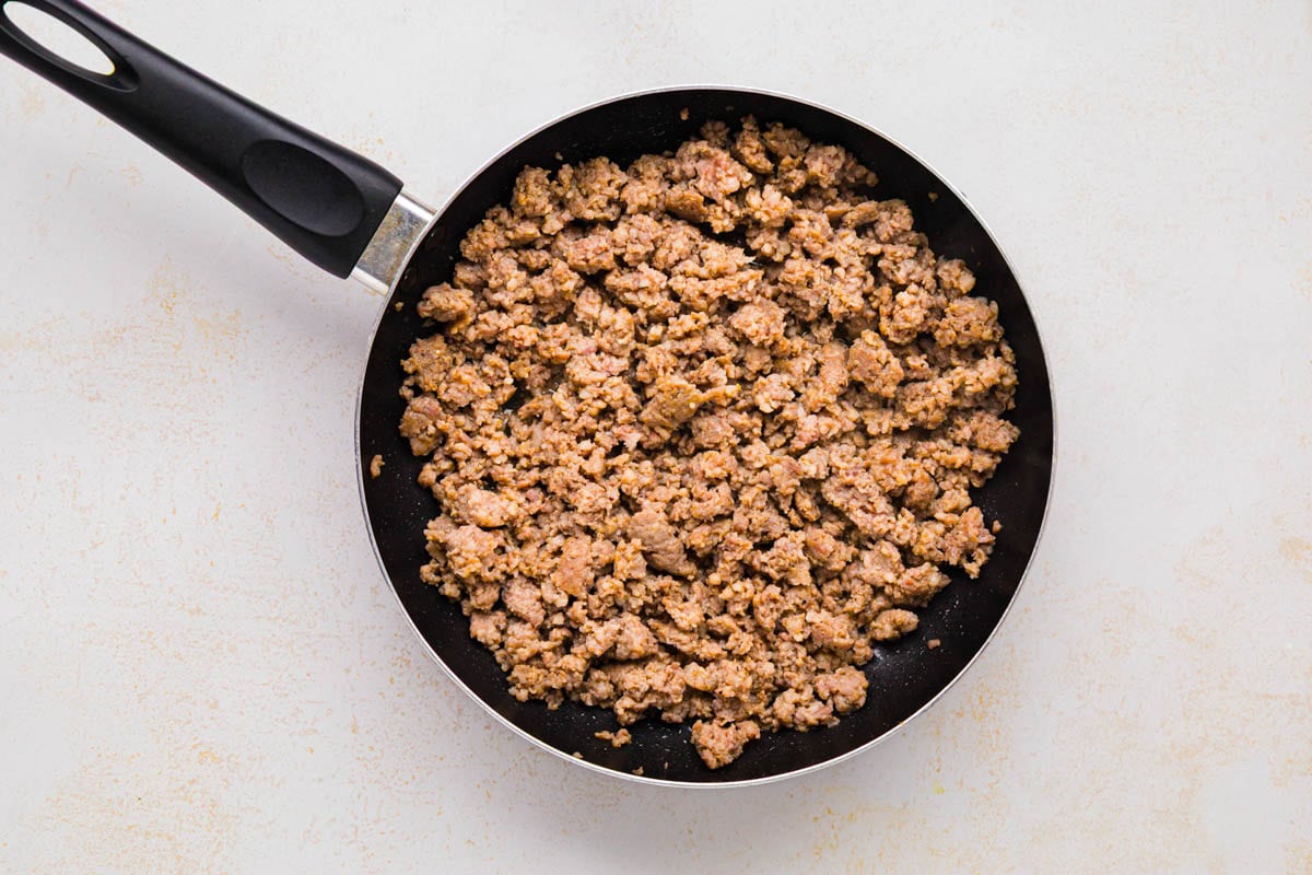 Browned sausage in a skillet.