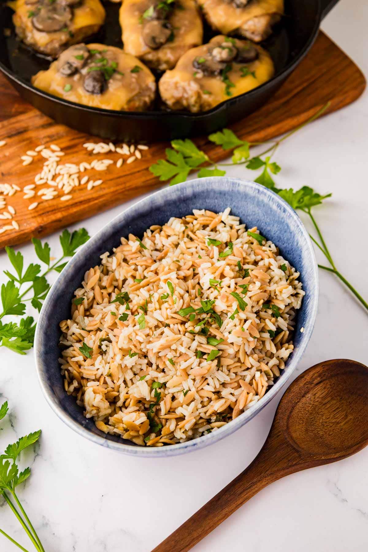 Rice pilaf in a blue serving bowl.