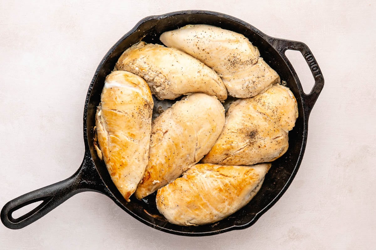 Cooking chicken breast in cast-iron skillet.