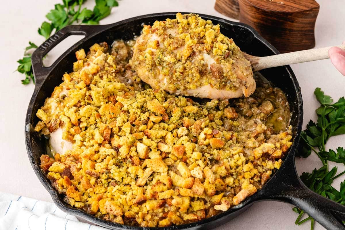 Baked creamy swiss chicken casserole with wine sauce in a cast iron skillet.