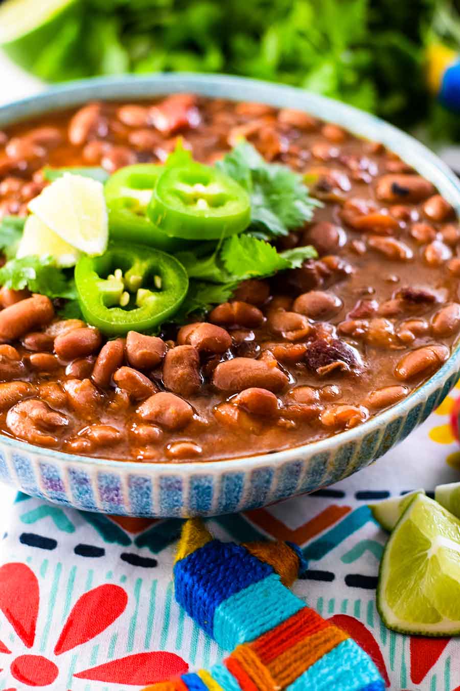 an overhead view of this instant pot charro beans recipe topped with jalapeno slices