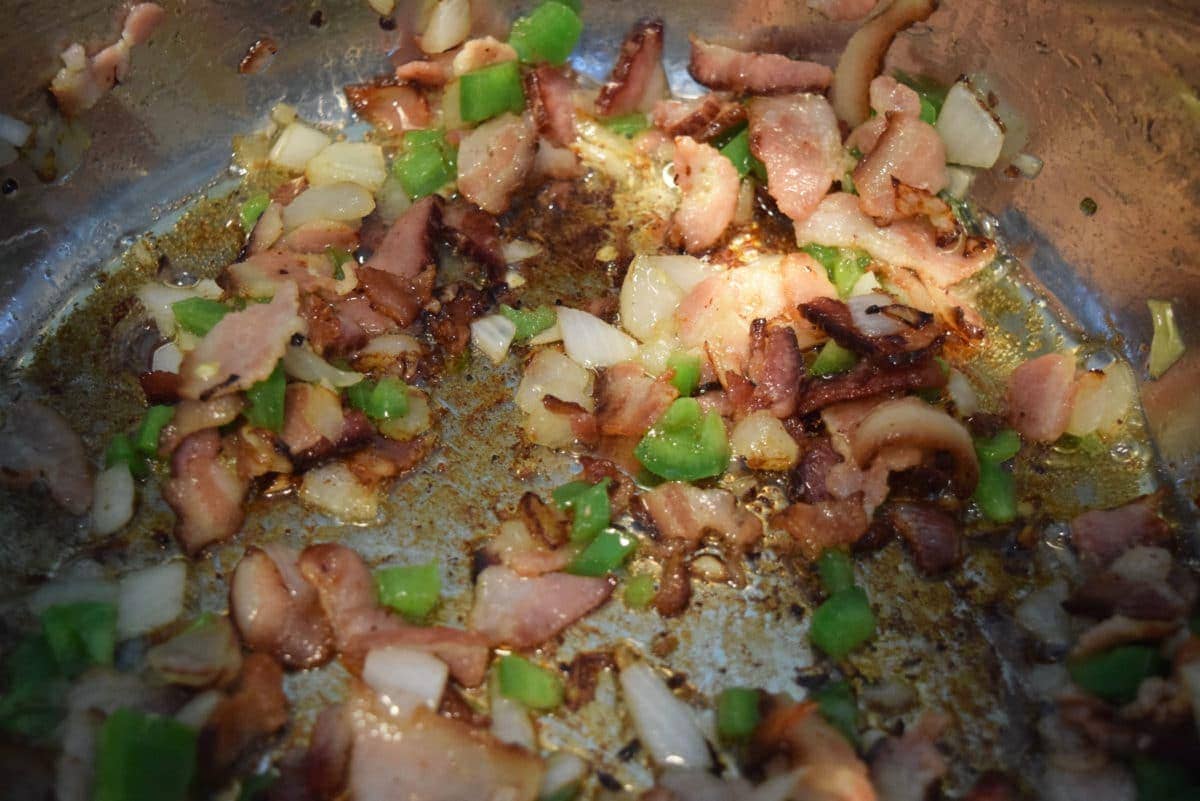a closeup of sautéing bacon to be used in these charro beans made in the instant pot or on the stovetop