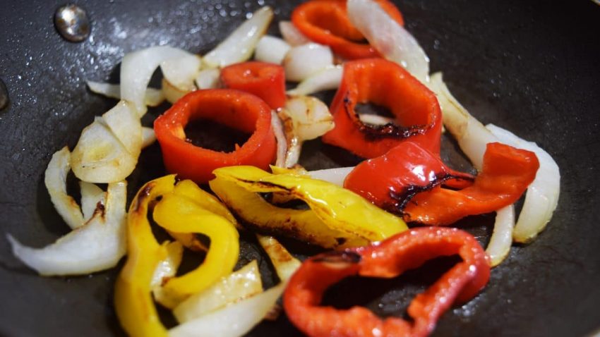 charred peppers and onions to be used in these easy italian chicken sausage sandwiches
