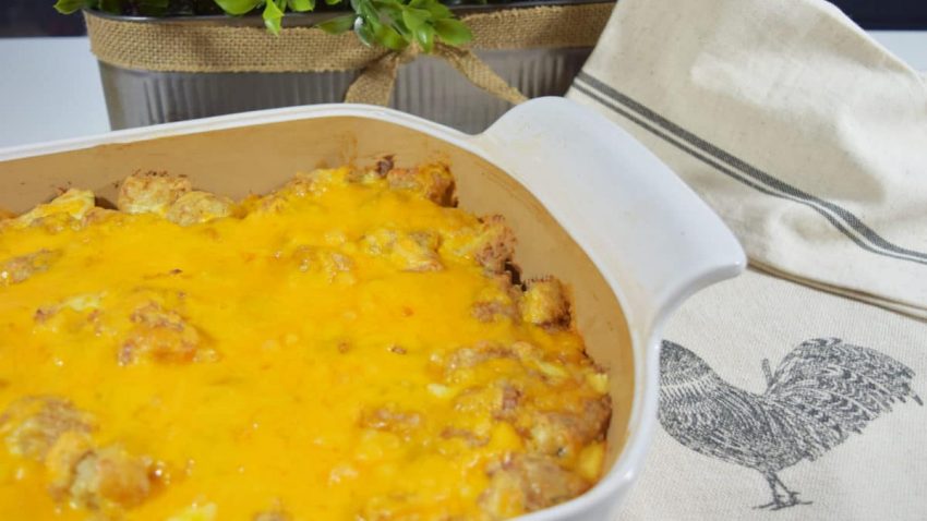 an overhead view of this cheesy chicken tender tater tot casserole recipe in a white casserole dish
