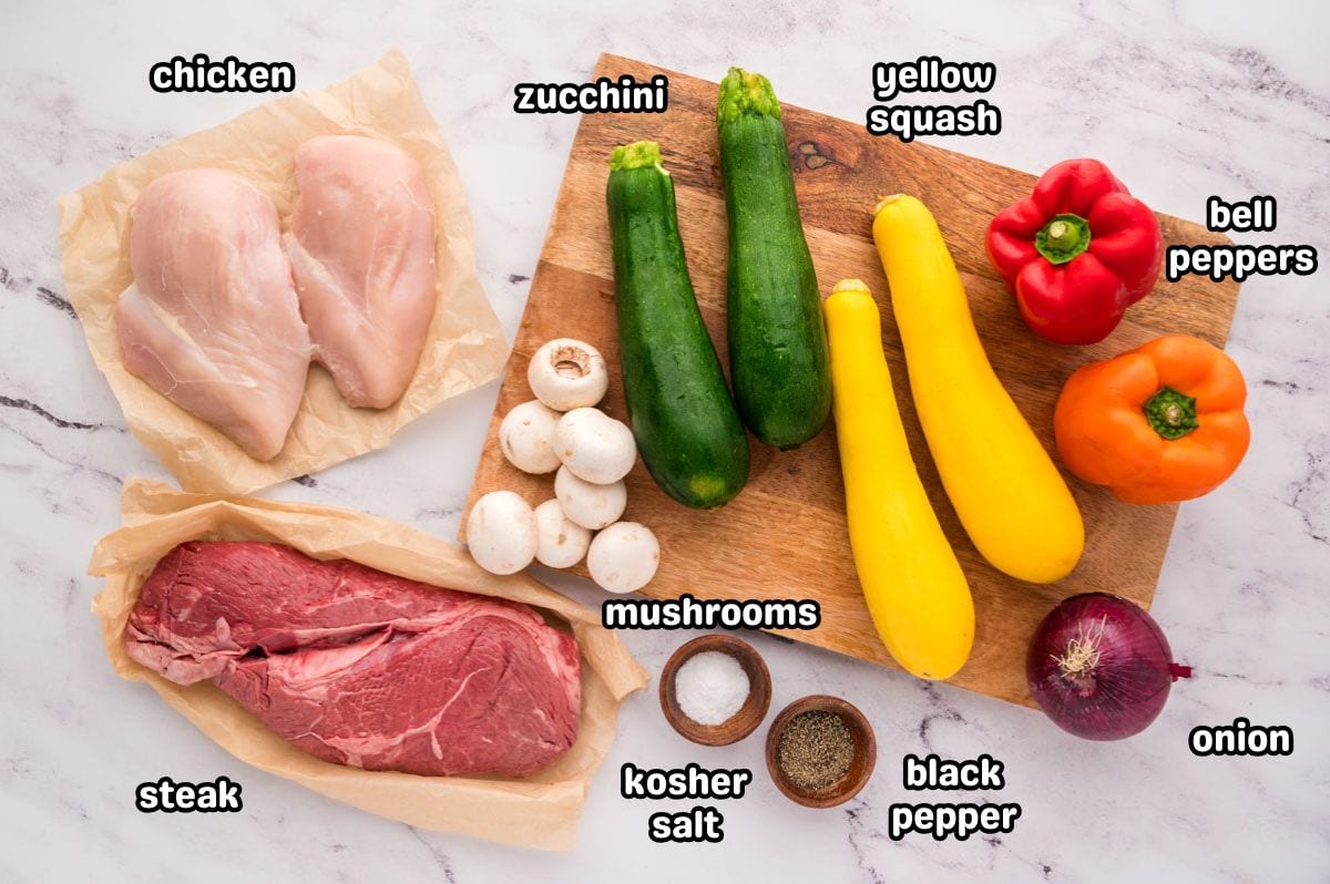 An image of labeled grilled steak and chicken skewer ingredients.