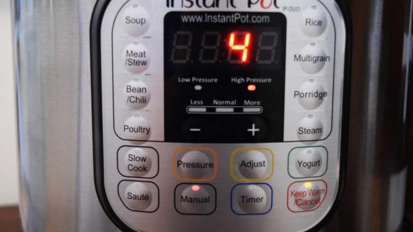 a closeup of an instant pot screen set to cook on high pressure for four minutes 