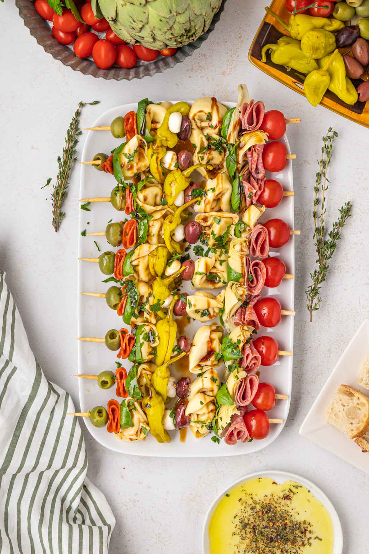 Antipasto skewers on a white serving platter.