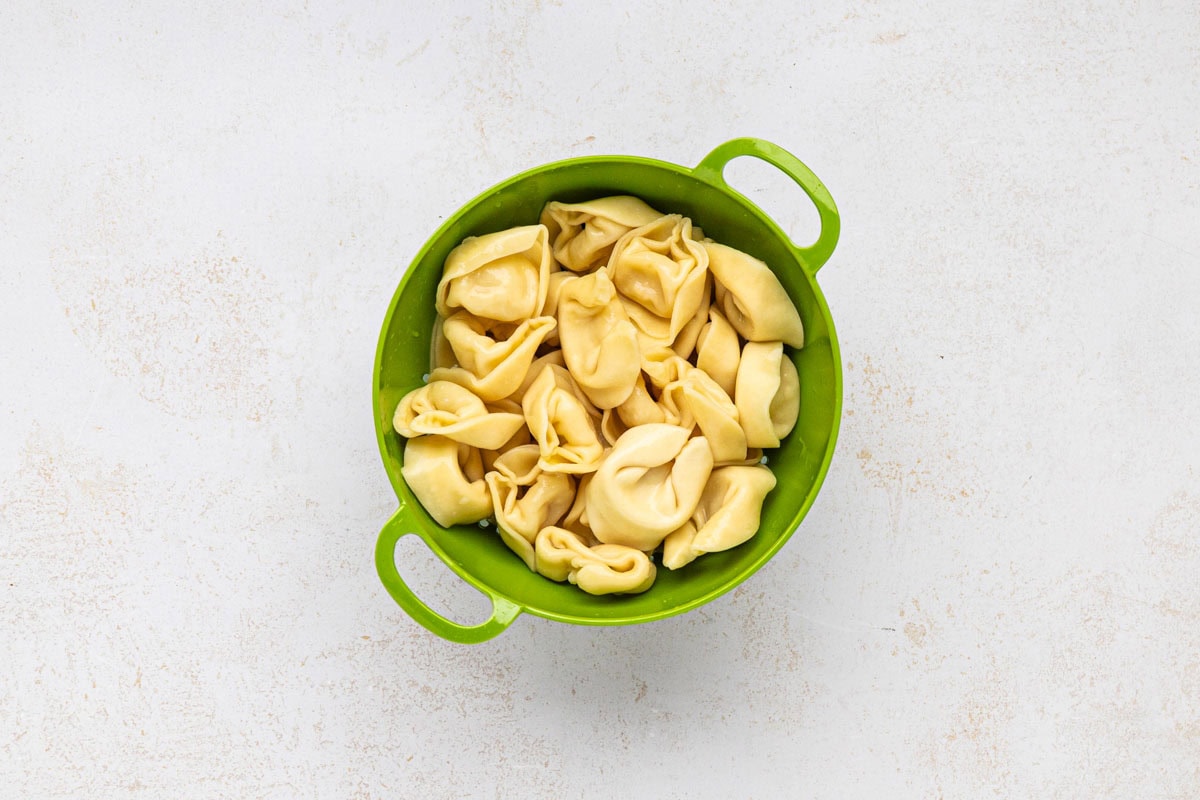 Tortellini draining in a colander.