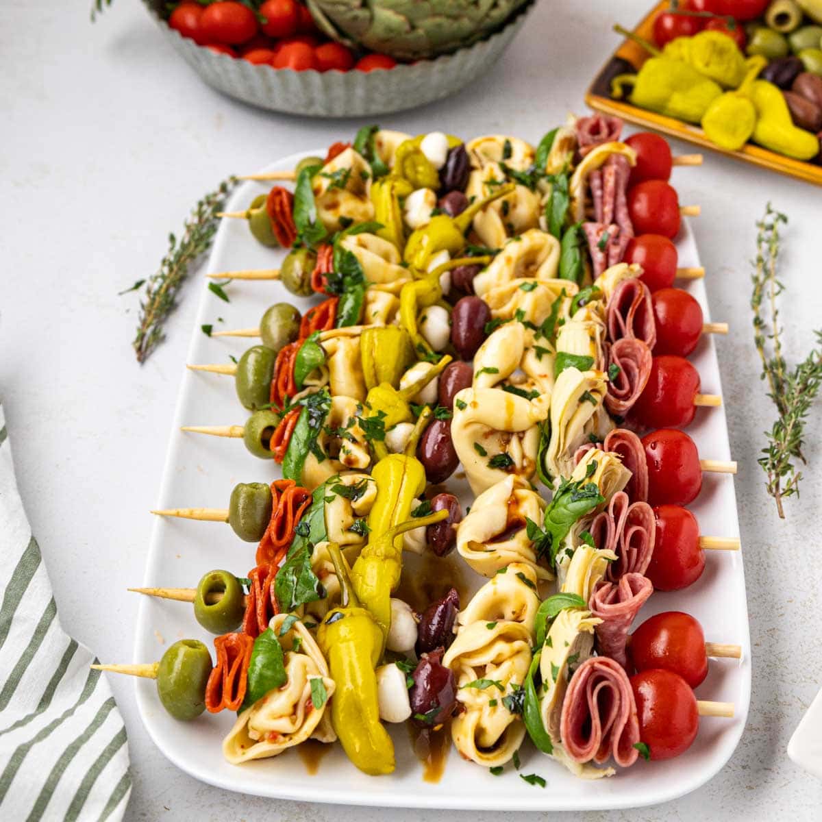 Antipasto skewers on a white serving platter.