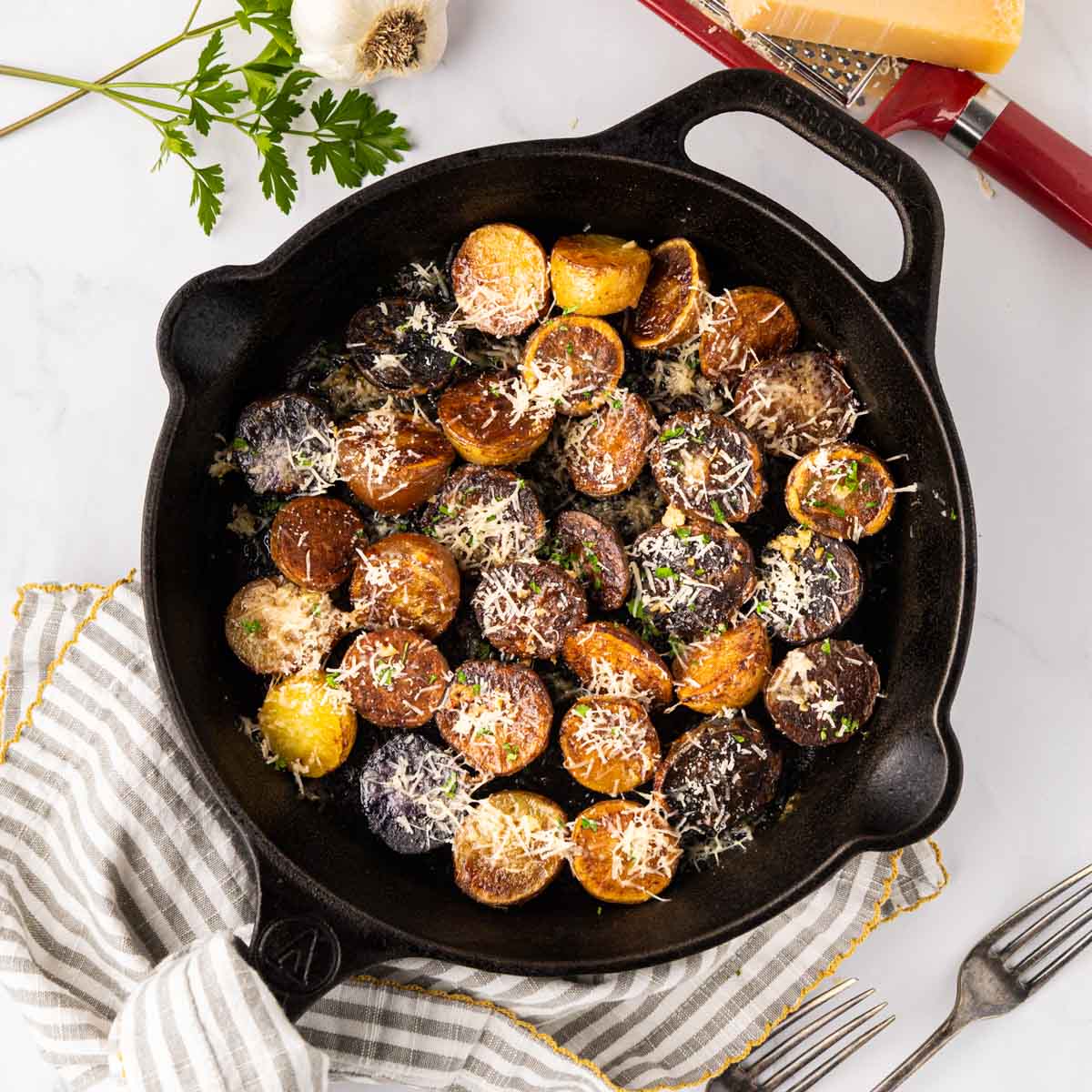 Garlic Parmesan potatoes in a cast iron skillet.