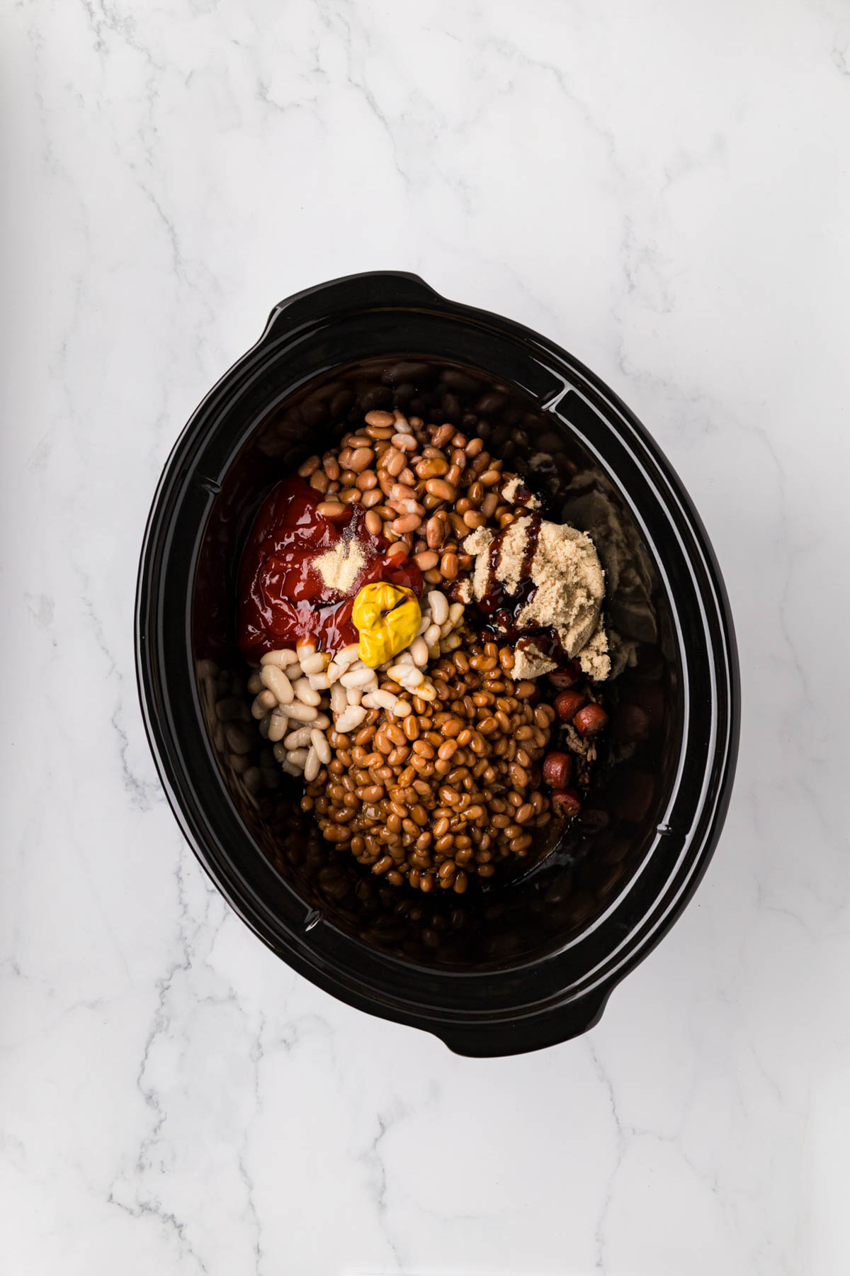 Ingredients to make franks and beans in a slow cooker.