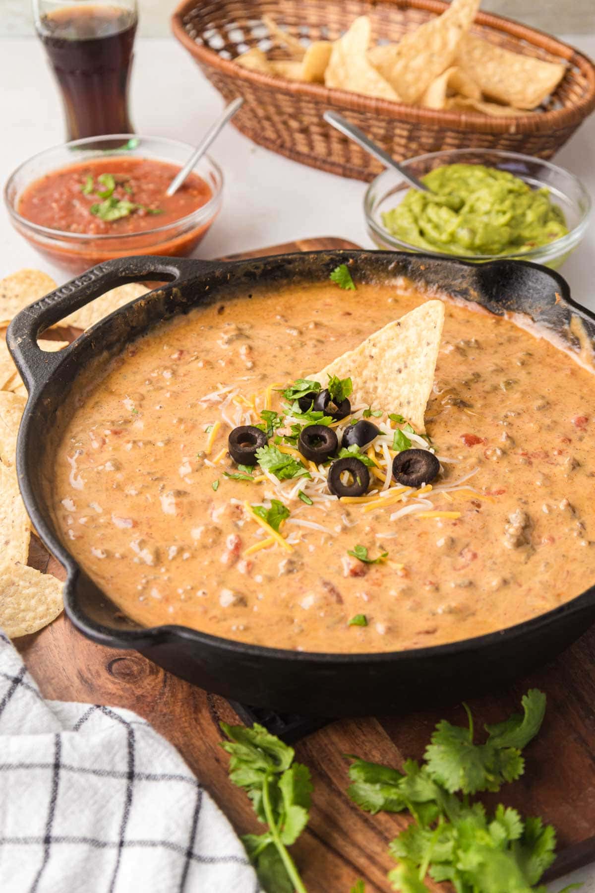 Cheesy Rotel Dip With Ground Beef in a cast iron skillet.