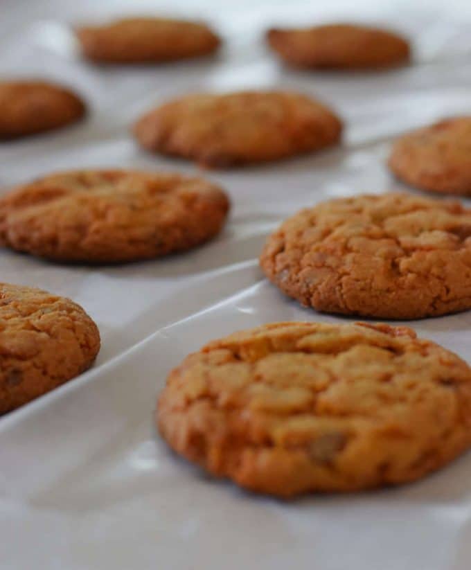 several cooked butterfinger cake mix cookies on a lined baking sheet