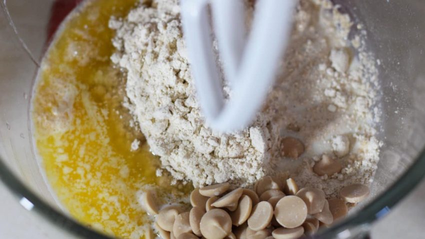 the ingredients needed to make this caramel pumpkin spice crunch cake recipe inside of a stand mixer