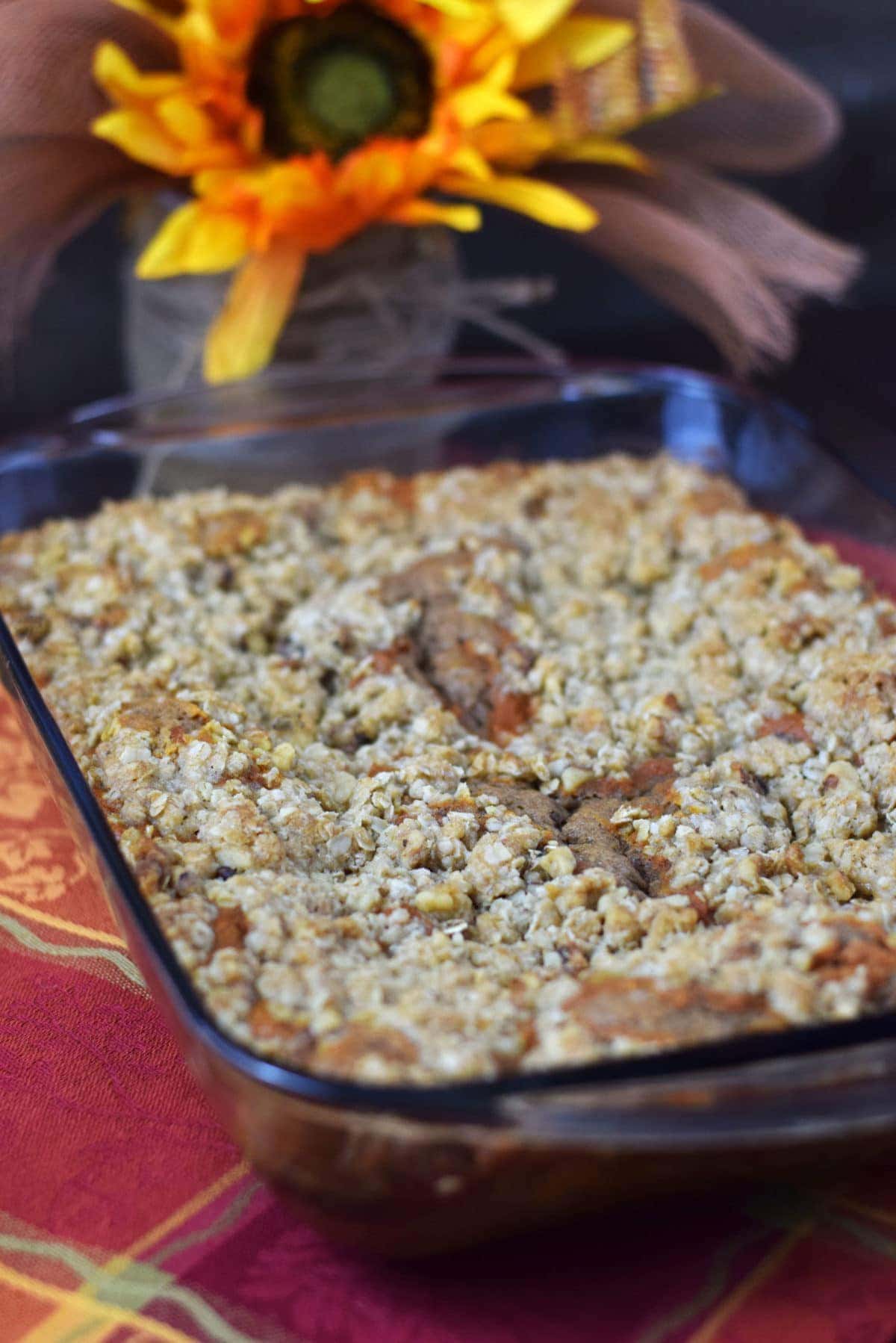 an overhead view of this caramel pumpkin spice crunch cake inside of a glass baking dish