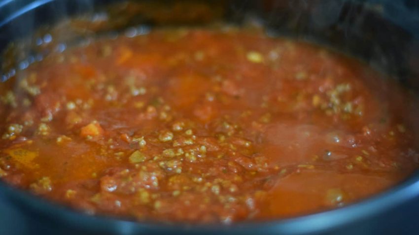 a closeup of the meat sauce for this ultimate baked spaghetti recipe
