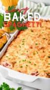 Easy ybaked spaghetti is in a white 13x9 baking dish with parsley and lots of cheese.