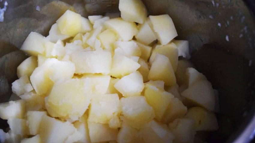 a closeup of cooked chopped white potatoes for this instant pot mashed potatoes recipe