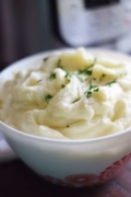 A close up of these Instant Pot Mashed Potatoes in a white bowl