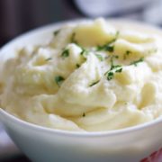 A close up of these Instant Pot Mashed Potatoes in a white bowl