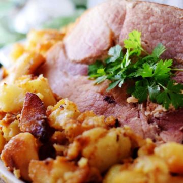 a closeup of this rustic ham and potatoes recipe garnished with green parsley