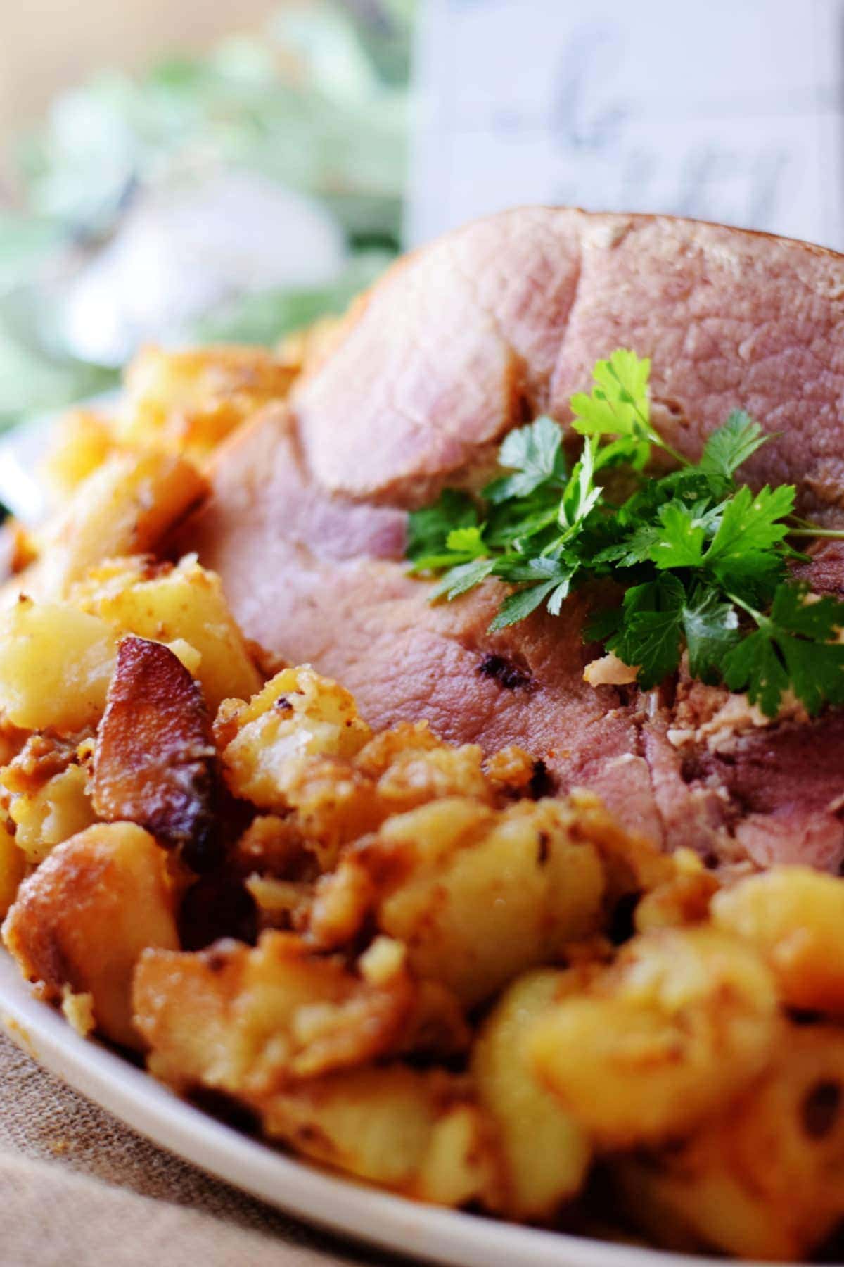 a closeup of this rustic ham and potatoes recipe garnished with green parsley