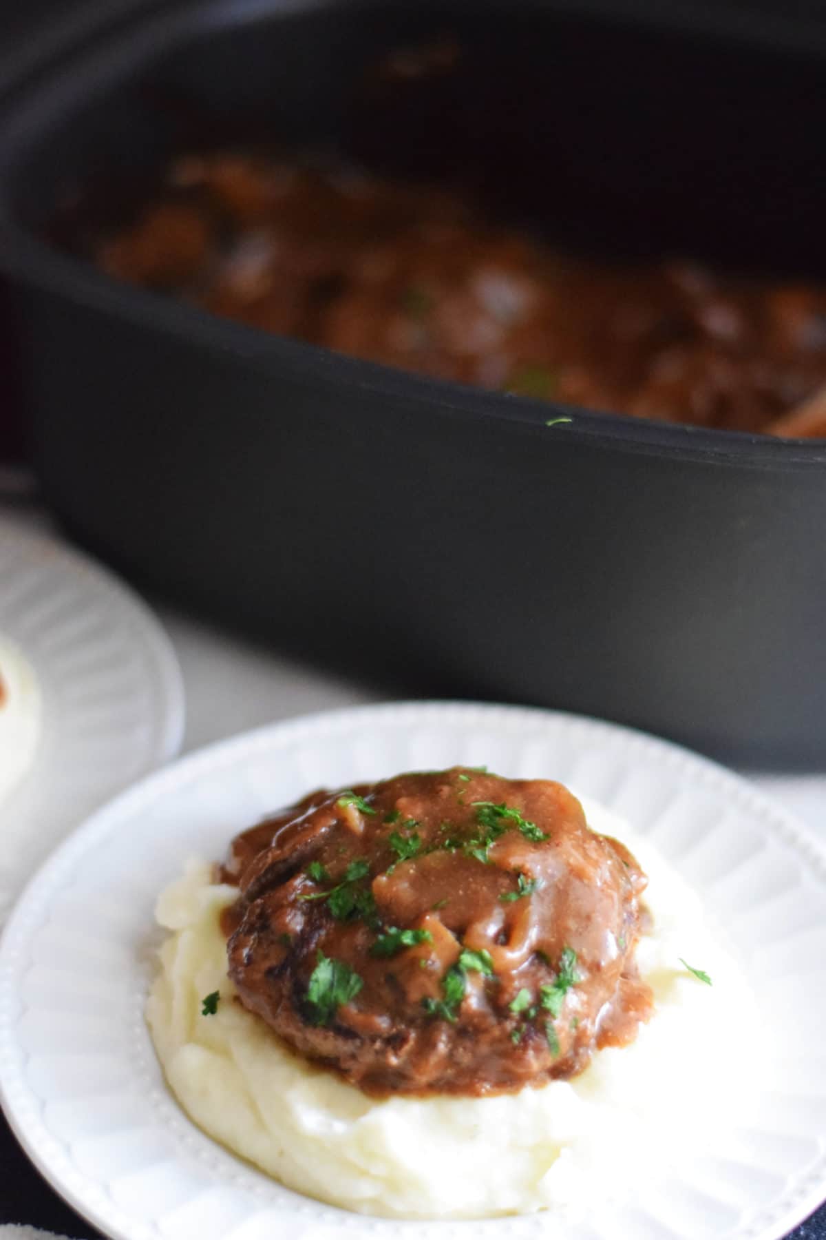 an overhead view of this slow cooker salisbury steak recipe on a white plate