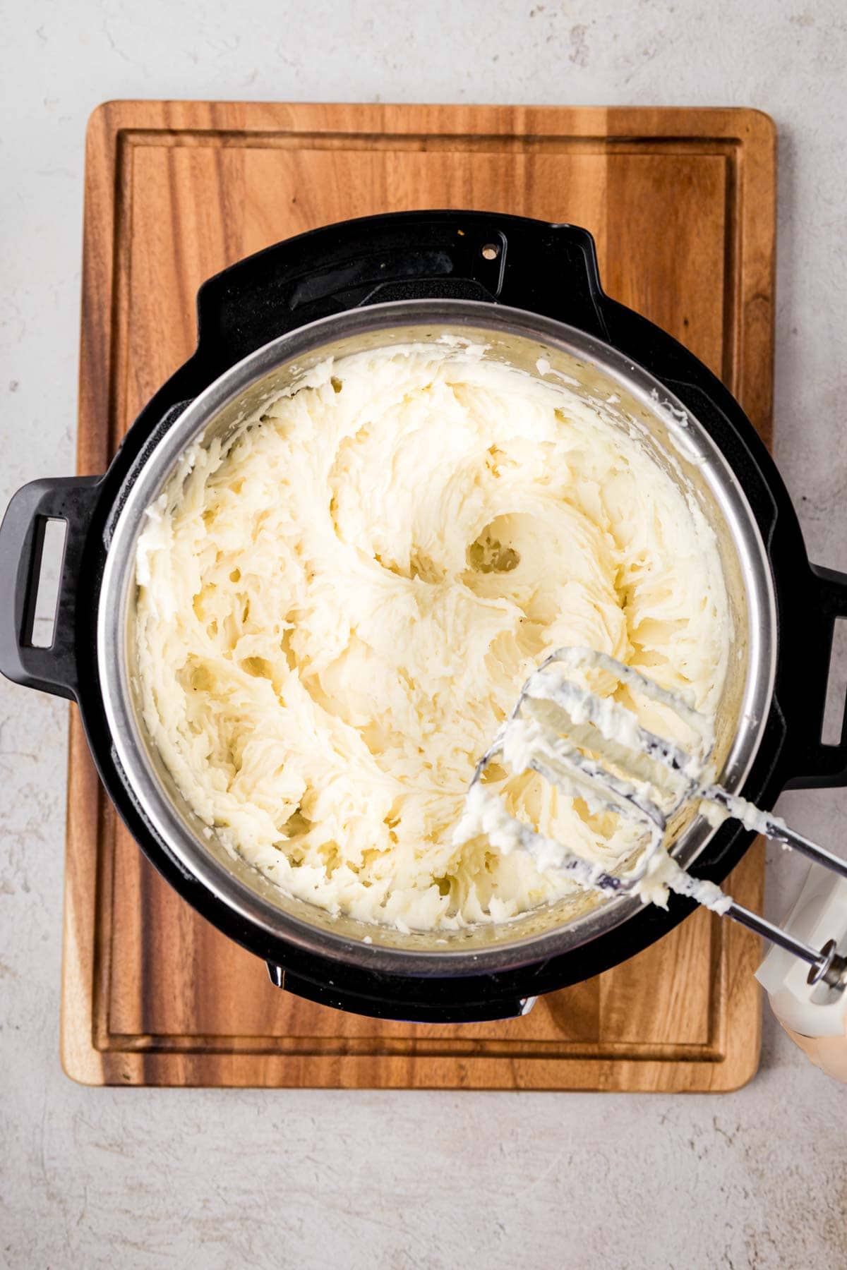 Using electric beaters to mash potatoes in the instant pot.