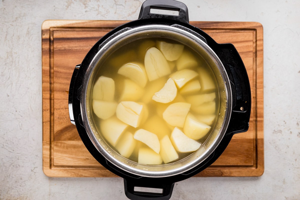 Chicken bullion and salt stirred water into the Instant Pot with the potatoes and water.