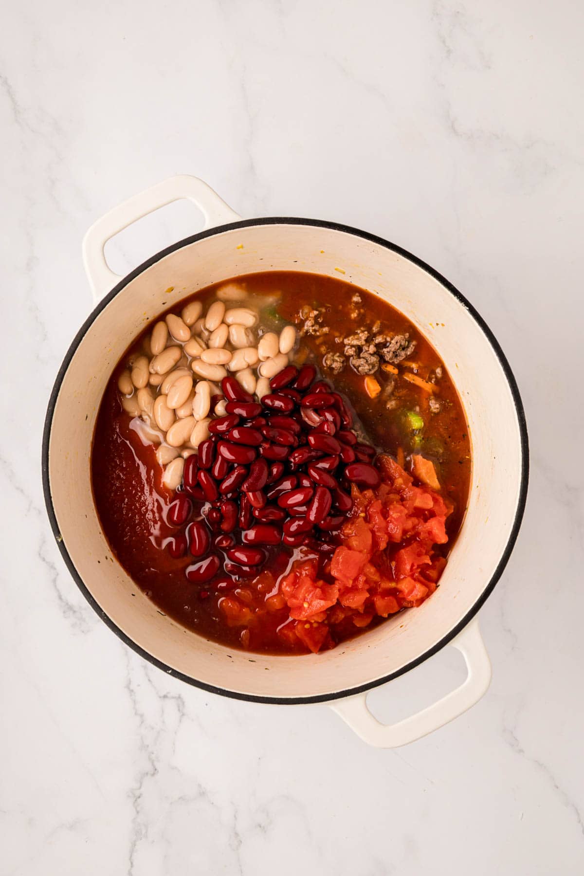 Beans, tomatoes, v8 juice and tomato sauce added to the soup pot.