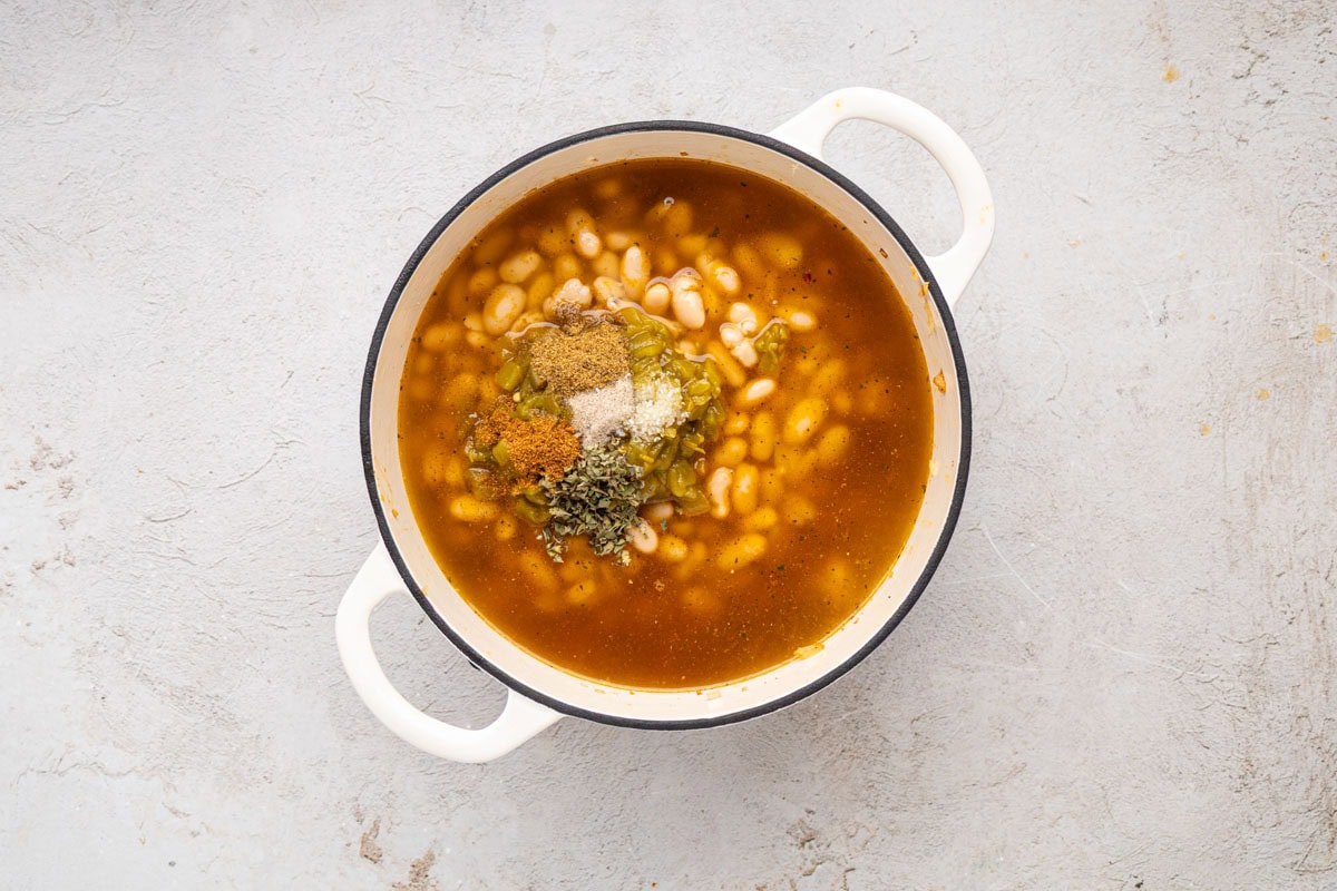 Seasonings and beans added to the soup.